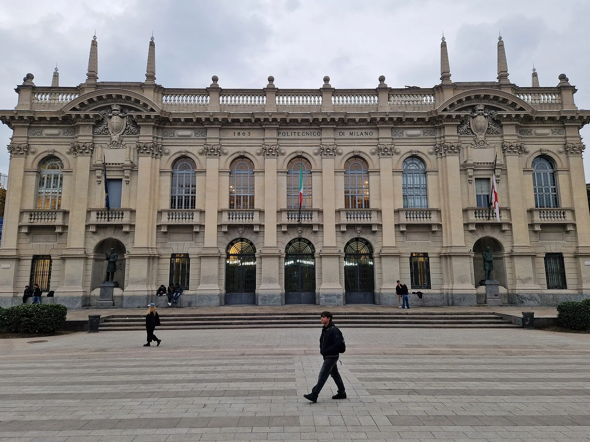 Main Leonardo campus building of Politecnico di Milano, with people crossing the square
