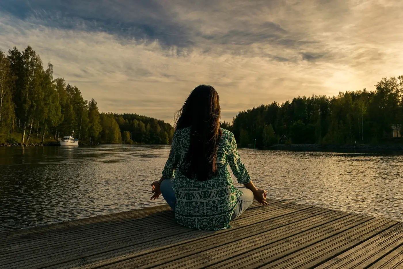 Person practicing yoga beside a lake at sunset, used as domain context for the PoliYoga web application